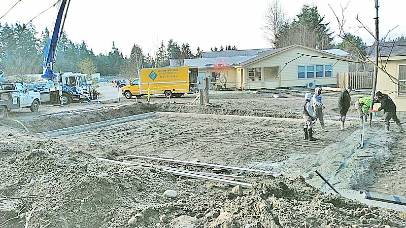 Concrete foundation forms being prepared on a job site
