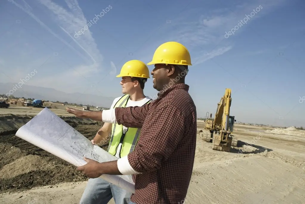 Construction team reviewing plans together on site